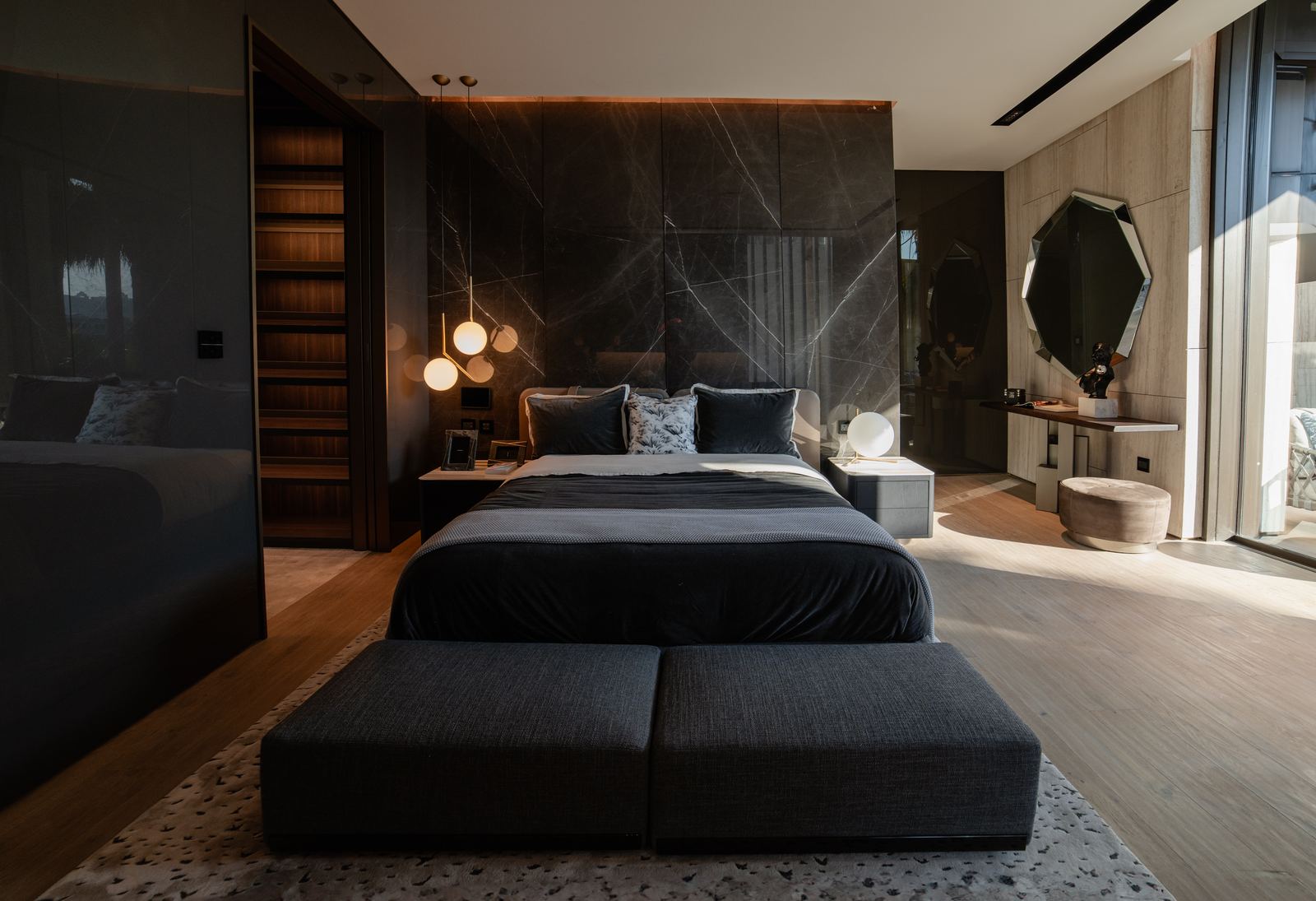 Luxurious bedroom with stone accent wall