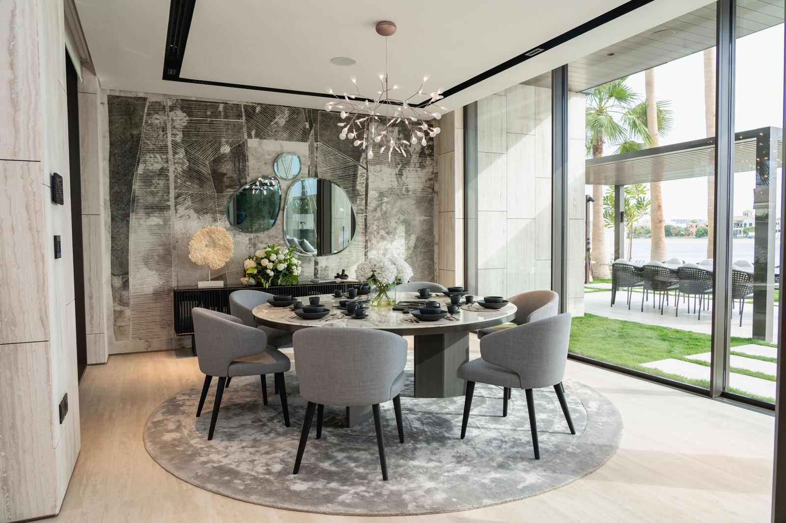 Sunlit dining room with sculptural chandelier