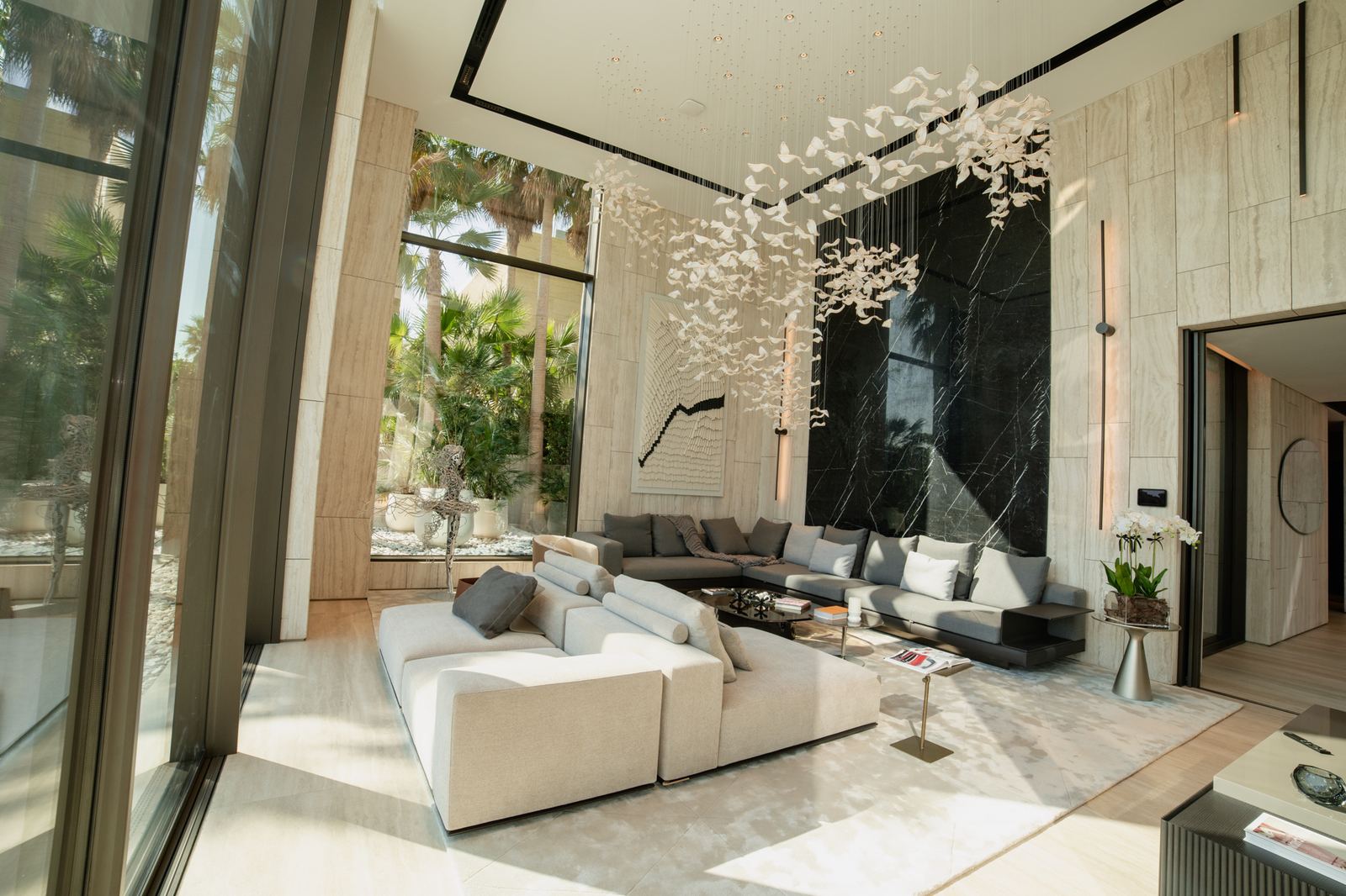 Palm-framed salon with sculptural installation